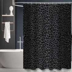 a black and white shower curtain with a leopard print pattern on it in a bathroom