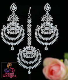 Beautiful Rhodium plated American Diamond stone studded Mughal style Earrings and maang tikka set. The design is a combination of chandbali and floral motif embellished with teardrop and marquise cut Cz Mint Green stones. The length of the earrings is 3.75 and the width is 1.75 inches Punjabi Earrings, Maang Tikka Set, Indian Designs, Diamond Wedding Jewelry, Wedding Indian, Maang Tikka, Green Stones, Color Stones, Long Drop Earrings