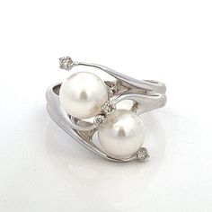 White Pearls and Diamond Vintage 14k White Gold Bypass Ring ~  Vintage Estate ~ Size 8.5 -  ET2175 A unique take on a white pearl and diamond bypass ring!  This ring gives the impression of swirling movement and looks absolutely stunning on. Ring Size: 8.5: can be resized Metal Content: 14k White Gold Gemstones:  2 White Cultured Pearls Size in mm: 8 Diamonds: 4 Natural/Genuine Round Brilliant Cut Carat: .08 ctw Clarity: SI1-SI2 Color: G/H Weight: 6.42 Grams Stamps: 14k 585 Cardow Condition: Very Good Estate- Small divots noted to pearl nacre Each piece is thoroughly examined and refinished as needed by our professional jewelers, tested to guarantee metal content,  graded by our in-house GIA (Gemological Institute of America) Graduate Gemologist, and inspected for quality before being care White Diamond Ring With Polished Finish In 14k Gold, White 14k Gold Diamond Ring Hallmarked, Elegant Polished Bypass Ring For Anniversary, Classic White Bypass Ring For Formal Occasions, Diamond White Bypass Ring For Formal Occasions, Formal Diamond White Bypass Ring In Fine Jewelry Style, Fine Jewelry White Pearl Ring Stamped 14k, White Pearl Ring Stamped 14k, Timeless White 14k Stamped Rings