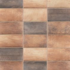 a brown and black tile wall with different colors