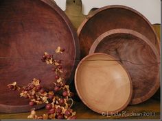 several wooden bowls and plates on a table