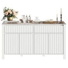 a white cabinet with flowers and candles on top