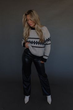 DETAILS: Our Maeva Cable Knit Sweater is a stand out piece for your wardrobe! This sweater has a twisted detail throughout the sweater that adds a unique and eye-catching element to its design. The neckline is a high scoop and there is a thick black trim on the neckline, cuffs, and hemline. The sweater has small cable knit and very soft to touch material. It has stretch and runs true to size. Pair this sweater with leggings or jeans and your favorite boots for a cute outfit!! CONTENT & CARE: 47% Polyester. 35% Acrylic. 15% Nylon. 3% Spandex. SIZE & FIT: Model is 5'6" The model is wearing a size small. Fits true to size The Fabric has stretch Chic Stretch Chunky Knit Sweater, Knit Top For Night Out In Fall, Fall Crew Neck Knit Top For Night Out, Chic Cable Knit Crew Neck Sweater, Chic Crew Neck Cable Knit Sweater, Casual Winter Knit Top For Night Out, Casual Knit Top For Winter Night Out, Chic Fall Sweater For Night Out, Trendy Cropped Sweater For Winter Nights