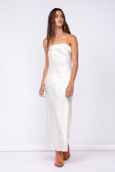 STYLE INFORMATION: The Irene Cream Satin Strapless Maxi Dress is the perfect date night dress! Cream satin fabric shapes this strapless maxi dress with a cowl back and a ruched elastic strap. Pair with some gold jewelry and strappy heels for a night out on the town. DETAILS & CARE: 95% Polyester/ 5% Spandex Hand wash cold. Imported. SHIPPING: Orders are processed within 1-2 business days. Packages are shipped out Monday-Friday, holidays are excluded. Elegant Strapless Backless Summer Dress, Summer Bandeau Maxi Dress For Prom, Bandeau Maxi Dress For Summer Prom, Chic Strapless Backless Dress For Prom, Elegant Backless Dress With Straight Neckline For Spring, Bandeau Dress With Ruched Bodice For Wedding, Chic Bandeau Prom Dress, Bandeau Wedding Dress With Ruched Bodice, Spring Strapless Backless Satin Dress