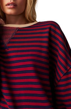 Zesty stripes lend nautical flair to a French terry sweatshirt fashioned in an oversized silhouette with bright ribbed contrasts. 28" length (size medium) Crewneck Long sleeves 66% cotton, 34% polyester Machine wash, tumble dry Made in the USA Navy Top With Contrast Stripes For Fall, Fall Striped Hem Top For Loungewear, Cotton Striped Sweatshirt With Striped Cuffs, Striped Crew Neck Sweatshirt For Loungewear, Fall Striped Sweatshirt With Striped Cuffs, Striped Sweatshirt With Striped Cuffs For Fall, Oversized Striped Crew Neck Sweatshirt, Oversized Striped Sweatshirt With Crew Neck, Striped Relaxed Fit Sweatshirt For Fall