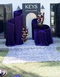 the entrance to key's soul care is decorated with purple drapes and flowers