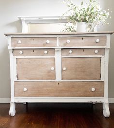 an old dresser with white knobs and drawers on top is shown in this image