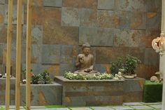 a buddha statue sitting on top of a stone bench