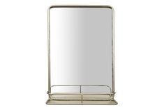 a large mirror sitting on top of a metal shelf