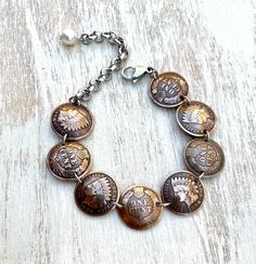 "THIS ITEM IS IN STOCK AND SHIPS  VIA USPS MAIL AMERICAN HERITAGE COLLECTION Indian Head Penny- minted 1859-1909 The perfect gift for any one who loves American history or vintage coins! This is a lovely bracelet made with 8 domed and polished Indian Head pennies. Made with alternating heads and tails (because the back is just as beautiful as the front). The pennies are connected with stainless steel links. It closes with a stainless steel lobster claw clasp and is finished with a freshwater pea Engraved Heirloom Metal Jewelry, Bronze Stamped Jewelry For Anniversary, Adjustable Heirloom Jubilee Bracelet, Heirloom Nickel-free Jewelry, Engraved Round Copper Jewelry, Antique Nickel-free Bracelet, Heirloom Bracelet Collectible Jewelry, Heirloom Collectible Bracelet Jewelry, Vintage Handmade Round Chain Bracelet