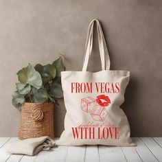 a tote bag sitting next to a potted plant