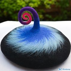 a blue and purple object sitting on top of a white table