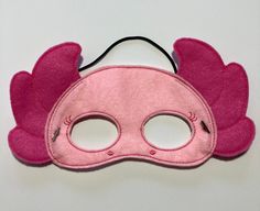 a pink mask with wings on it