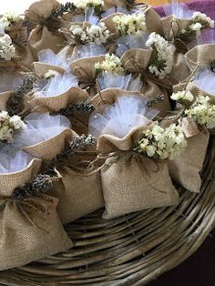 baskets filled with white flowers and burlocks on top of a purple table cloth