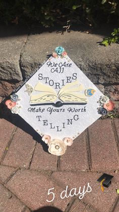 a graduation cap sitting on top of a brick sidewalk with the words, 5 days