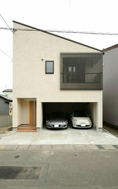 two cars are parked in front of a house