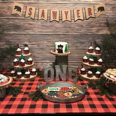 a table topped with lots of cupcakes and cakes