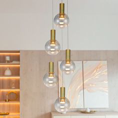 a modern chandelier hanging from the ceiling in a living room