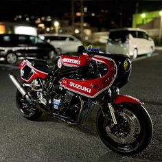 a red and black motorcycle parked on the street