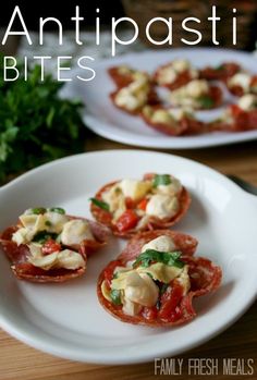 small appetizers are on a white plate with parsley in the back ground