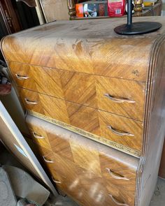 an old wooden dresser with many drawers in it's storage area, next to a pair of shoes