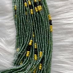 New style of authentic waist beads or belly jewelry for our women. These waist beads are green and gold and can be worn for several purposes such as weight loss track, body jewelry, spiritual intention and cultural representation. We have new style every week! You will receive one strand of 45 inches waist beads tie on. When it comes, you just adjust where you want it to on your belly or hips, tie it securely and cut out the loose part. You are ready to go! Beaded waist beads are special body je Traditional Green Beads For Festival, Traditional Green Spacer Beads, Traditional Green Hand-strung Beaded Necklaces, Traditional Green Beaded Necklace With Gold Beads, Green Waist Beads For Beach, Green Spiritual Jewelry With Tiny Beads, Green Multi-strand Hand-strung Beaded Necklaces, Green Multi-strand Beaded Necklaces For Festivals, Traditional Green Beaded Bracelets With Spacer Beads