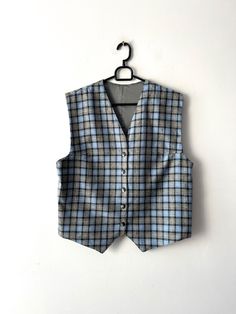 "Vintage Large classic women's vest Wool blend plaid vest Women's formal vest Blue Checkered  Waistcoat Button Up office Vest Estimated size: L Measurements (lying flat): Length: 21\"/ 53.5 cm Pit to pit: 20\"/ 50.7 cm Waist: 20.\"/ 50.7 cm Please check measurements to insure a proper fit. Remember to allow yourself some extra room for movement. You can compare these with something from your closet that fits you well. This vest will come to you freshly laundered and ready to wear. Please convo me if you need additional measurements. Condition: great Vintage Condition SHIPPING * I ship worldwide via Priority mail (Latvijas Pasts) from Latvia (EU). * I ship from Europe, so please allow 2 to 4 weeks for the package to arrive if you live overseas. * Europe 5 - 10 business days. Thanks for the Classic Wool Vest For Office, Classic Plaid Vest For Fall, Tailored Winter Vest For Office, Tailored Office Vest For Winter, Sleeveless Vest For Business Casual Winter, Fitted Plaid Vest For Winter, Classic Plaid Vest, Classic Plaid Sleeveless Vest, Classic Sleeveless Plaid Vest