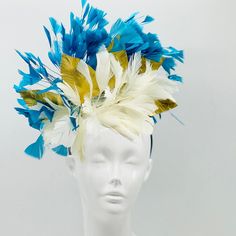 Handmade by Featured Milliner of The Kentucky Derby Museum 2023 & 2024! Blue, white and gold Kentucky Derby Fascinator Attaches with headband.  Not taking customs this year--Derby 150 is going to be massive and mom life keeps me running! However, happy to suggest pieces that will coordinate with your outfit. If you don't love the way this attaches to your head--message me!  I can swtich *most* pieces to your preference. Clip, Headband OR Elastic Cord  NOTE: Heavier pieces with extravagant floral Gold Pinched Crown Headpiece For Kentucky Derby, Gold Headband For Kentucky Derby, Gold Headpiece For Kentucky Derby, Gold Headpieces For Kentucky Derby, Gold Mini Hat Headband For Royal Ascot, Gold Fascinator For Kentucky Derby, Gold Wedding Fascinator With Feathers, White Headpiece For Royal Ascot With Pinched Crown, White Structured Crown Headpiece For Royal Ascot