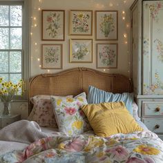 a bedroom with flowers on the wall and pictures above the bed, along with lights