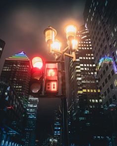 a traffic light in the middle of a city at night