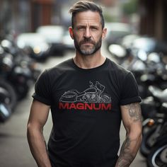 T-Shirts for Victory Magnum Motorcycle Riders Do you ride a motorcycle? Check out our t-shirts inspired by the Victory Magnum This high-quality shirt is designed to be the perfect combination of style and comfort during your motorcycle journeys.  This tee shirt serves as the ultimate homage to these legendary motorcycles that have stolen the hearts of riders worldwide. You can also find hoodies with these same designs in our shop.  This classic unisex short sleeve biker shirt offers ample room for your motorcycle riding movements. The soft cotton and quality print will make you fall in love with it over and over again. It comes with ribbed knit collars for enhanced shaping. Shoulder taping ensures a better fit over time, and dual side seams maintain the garment's shape for the long haul. Motorcycling Short Sleeve Screen Print T-shirt, Biker Style Short Sleeve T-shirt For Motorcycling, Black Cotton T-shirt For Motorcycling, Moto Style Cotton T-shirt With Short Sleeves, Moto Style Cotton Top With Graphic Print, Moto Style Short Sleeve T-shirt For Biker Events, Graphic Print Biker Shirt For Biker Events, Biker Style Shirt With Graphic Print For Biker Events, Cotton Biker Top For Biker Events