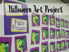 a bulletin board decorated with purple and green paper cutouts for the halloween art project