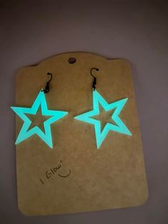 glow in the dark star earrings on a card with a tag attached to each earring