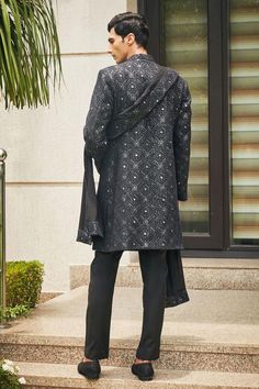 Black sherwani with floral Mughal chikankari embroidery and sequin highlights. Comes with matching dupatta, short kurta and pant.
Components: 4
Pattern: Embroidered
Type Of Work: Chikankari, Sequins
Neckline: Mandarin
Sleeve Type: Straight Full
Fabric: Sherwani and Dupatta- Georgette, Kurta and Pant- Terrywool
Color: Black
Other Details: 
Model height: 6ft, wearing size M
Occasion: Cocktail and Reception - Aza Fashions Designer Semi-stitched Kurta With Chikankari Embroidery, Black Sherwani With Chikankari Embroidery, Black Chikankari Embroidered Sherwani, Black Chikankari Embroidery Sherwani, Formal Black Unstitched Suit With Chikankari Embroidery, Designer Kurta With Dupatta For Diwali, Designer Black Sherwani With Chikankari Embroidery, Black Chikankari Embroidery Sherwani For Eid, Eid Black Sherwani With Chikankari Embroidery