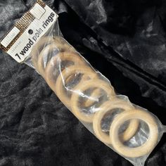 some pretzels are wrapped in plastic on a black cloth