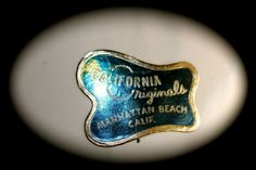 a close up of a blue and gold plate with the name california winemaker written on it