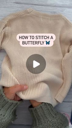 someone holding a sweater with the words how to stitch a butterfly on it