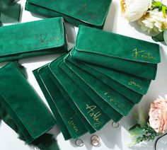 green velvet wedding rings and ring bearer's pouchs with gold writing on them