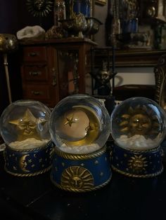 three snow globes sitting on top of a table