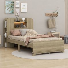 a bed sitting on top of a wooden floor next to a book shelf