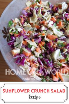 a bowl filled with coleslaw and carrots on top of a wooden table