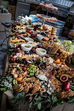 a buffet table filled with lots of different types of foods and desserts on it