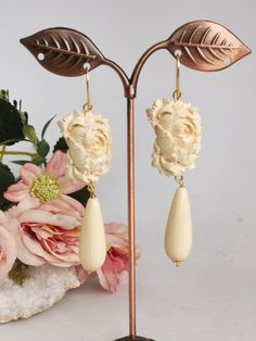 Pendant earrings with ivory paste drops imitation and cameo flowers in ivory paste handmade in Torre del Greco depicting flowers, 2.5 cm size, monachelle closure in 925 silver. total length 8 cm. Elegant Beige Flower Earrings Gift, Elegant Beige Flower Earrings For Gift, Elegant Cream Flower Earrings For Gift, Elegant Carved Flower Jewelry, Elegant Cream Flower Earrings, Elegant Beige Teardrop Earrings, Red Coral Earrings, Red Coral Necklace, Drop Earrings Silver