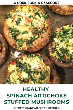 some stuffed mushrooms with spinach and other toppings in them on a baking sheet