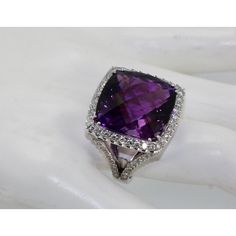 This is part of Chairish’s Fine Jewelry assortment.  This huge Amethyst ring is 25 carats of a mixed cut Amethyst.  This ring has a Diamond border and also Diamonds down the shank.  Just arrived from Italy and is an amazing piece.  This Amethyst is a cushion cut and the Diamonds total 1.50 carats for a total of 26.50 carats of gemstones.   This ring weighs in at 19 grams and is a US size 7.50 which can be re-sized up or down.  The color of this Amethyst is a deep Amethyst purple and matches the Amethyst earrings listed.  Amethyst is the birthstone of January babies but I love Amethyst it is a deep purple and glows especially at this size, 25 carats with a Diamond border of 1.50 carats.  Do not wait. Classic Luxury Diamond Amethyst Ring, Formal Amethyst Diamond Ring With Diamond Cut, Formal Amethyst Diamond Cut Ring, Formal Amethyst Diamond Ring With Diamond Accents, Formal Amethyst Rings With Diamond Accents, Purple Brilliant Cut Diamond Ring For Formal Occasions, Formal Purple Diamond Ring With Brilliant Cut, Elegant Amethyst Diamond Cut Ring, Formal Purple Amethyst Ring With Diamond Accents