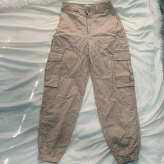 Abercrombie Pants Size Xs Tan Pockets On The Side (Cargo Style Pants) New With Tags Synched By The Ankle High Waisted High Waist Beige Utility Bottoms, High Waist Beige Pants With Pockets, Beige Utility Trousers, Casual Neutral Pants With Side Pockets, Fitted Beige Pants With Pockets, Beige Parachute Pants For Spring, Beige Cargo Bottoms With Long Pants, Beige Tapered Leg Parachute Pants With Pockets, Beige Long Pants With Cargo Pockets