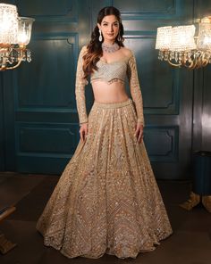 This lehenga set is hand embroidered in floral and geometric motis with a mix of light gold and sequin embroidered. Paired with a full sleeves embroidered wide-neck blouse and match dupatta.DELIVERY TIMEPlease allow 8-12 weeks for your outfit to arrive.FABRIC DETAILSNetProfessional cleaning only. Long Sleeve Choli With Dabka Work For Navratri, Anarkali Sets With Long Sleeves For Reception, Navratri Long Sleeve Reception Sets, Long Sleeve Sharara With Dupatta For Reception, Long Sleeve Anarkali Set With Mirror Work For Reception, Long Sleeve Sharara For Diwali Reception, Elegant Long Sleeve Palazzo Set With Pallu, Festive Long Sleeve Sets For Reception, Festive Long Sleeve Anarkali Set With Mirror Work