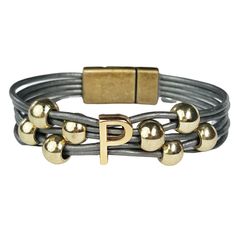 a leather bracelet with gold beads and a letter p on the clasp, all in different colors