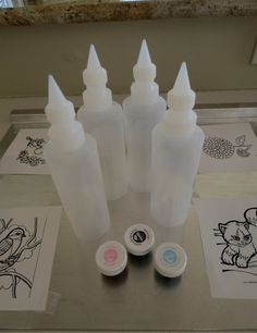 several different types of ink sitting on top of a table next to pictures and markers