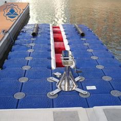 a boat is docked at the dock with blue tarps